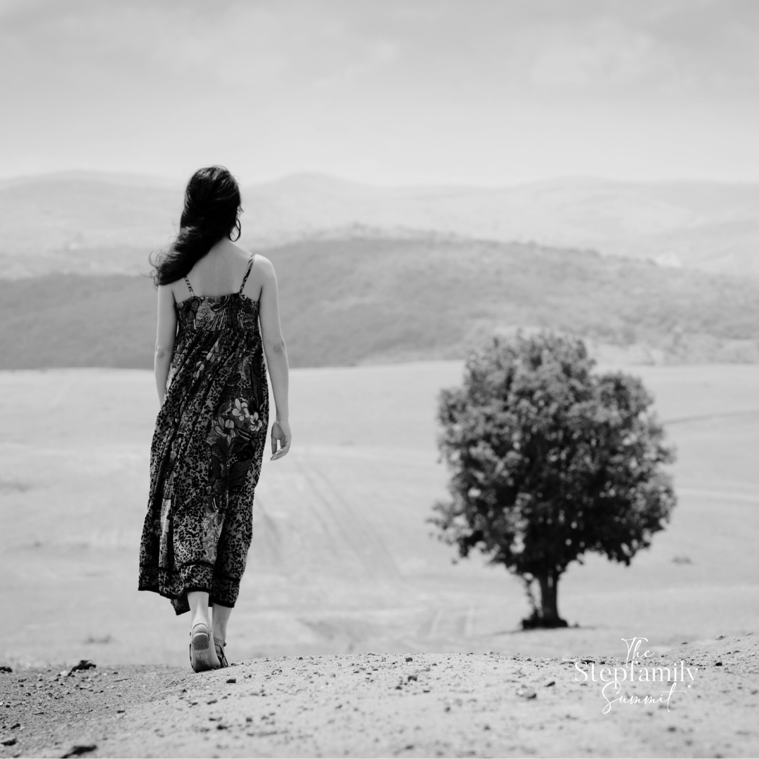 woman walking alone on a dirt road